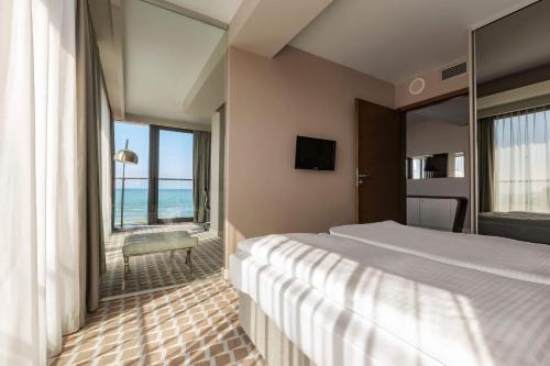 a hotel room with two beds and a view of the ocean at VacationClub – Marine Hotel Apartament 320 in Kołobrzeg