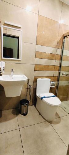 a bathroom with a toilet and a sink at AGS Residency in Ernakulam