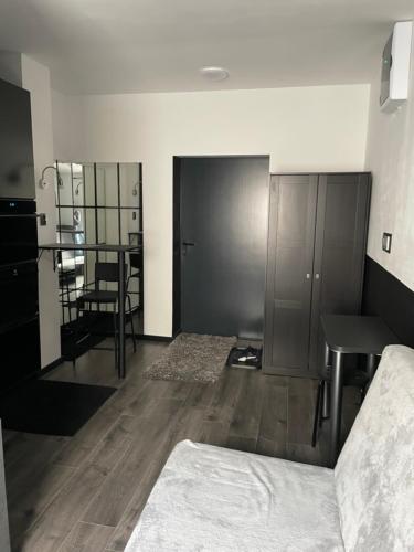 a bedroom with a bed and a desk and a table at Ingress in Bytom