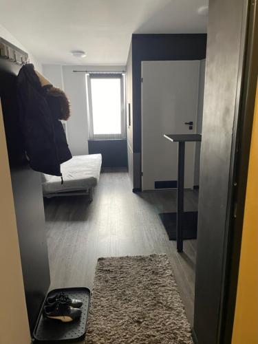 a room with a bed and a table and a rug at Ingress in Bytom