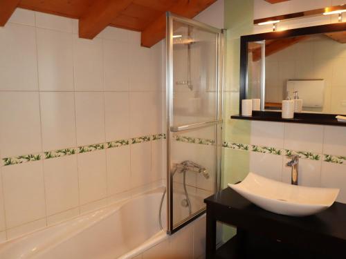 a bathroom with a tub and a sink and a shower at Chalet Samoëns, 5 pièces, 14 personnes - FR-1-624-7 in Samoëns