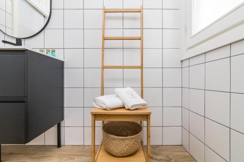 a bathroom with a ladder and towels on a stool at iloftmalaga Santa María in Málaga