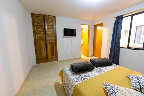 a bedroom with a bed with two pillows on it at Apartamentos Primavera in Jardin