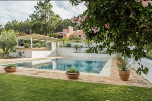 a swimming pool in the backyard of a house at Colorful Villa with pool by OTYNA AM in Estoril