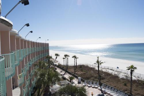 a view of the beach from the balcony of a building at Casa Loma Panama City Beach - Beachfront in Panama City Beach