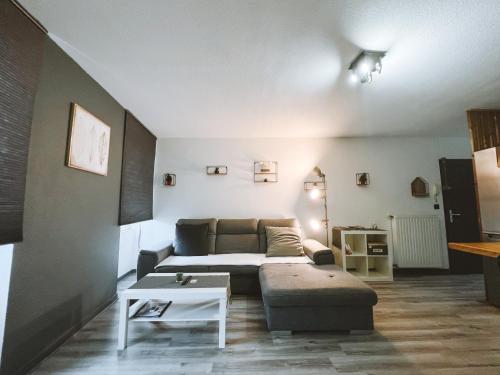 a living room with a couch and a table at Le DrômArdèchois - Gîte meublé 6 personnes Tournon sur Rhône - ÉCOLODGÎTE in Tournon-sur-Rhône