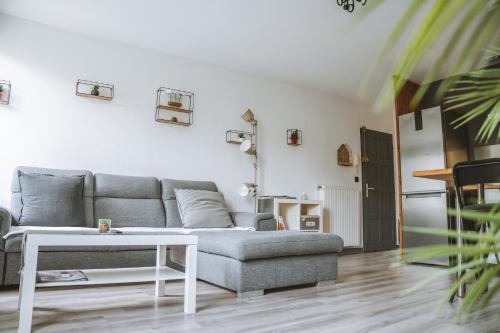 a living room with a couch and a table at Le DrômArdèchois - Gîte meublé 6 personnes Tournon sur Rhône - ÉCOLODGÎTE in Tournon-sur-Rhône