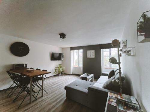 a living room with a couch and a table at Le DrômArdèchois - Gîte meublé 6 personnes Tournon sur Rhône - ÉCOLODGÎTE in Tournon-sur-Rhône