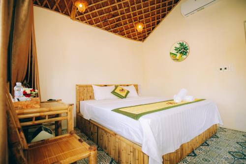 a bedroom with a bed and a chair at Tam Coc Sky Bungalow in Ninh Binh