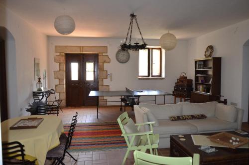 a living room with a couch and a table at Olive Cottage in Kyparissia