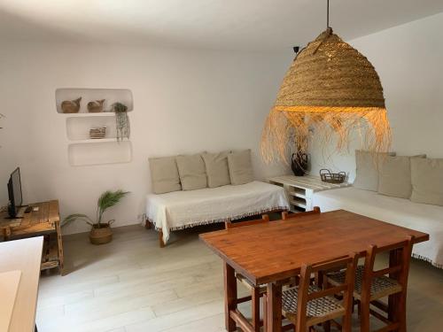 a living room with a table and a couch at Appartamentos Michel Dos in Sant Ferran de Ses Roques