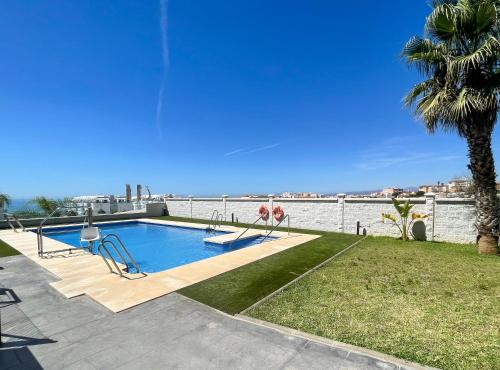a swimming pool with a view of the water at Cucurrox in Torrox