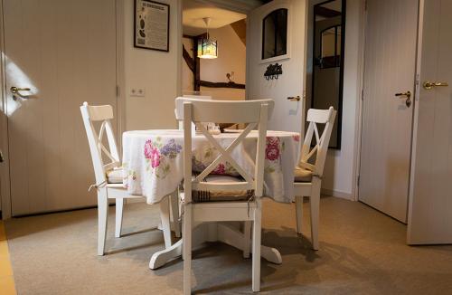 a table with two chairs and a table with a table cloth at Erve Nijkamp in Tubbergen