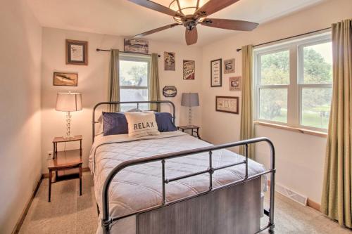 a bedroom with a bed and a ceiling fan at Bright Shawano Lake Oasis - Walk to Boat Launch! in Shawano