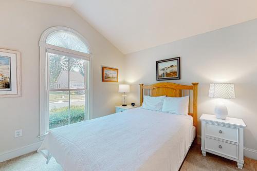 a white bedroom with a bed and a window at Grande at Canal Pointe 37484 Liverpool Ln in Rehoboth Beach