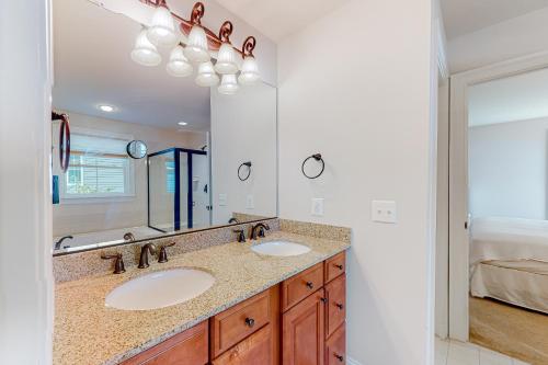 a bathroom with two sinks and a large mirror at Grande at Canal Pointe 37484 Liverpool Ln in Rehoboth Beach