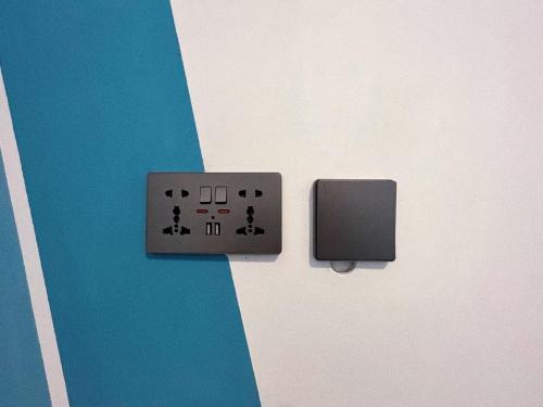 an electrical outlet with a switch on a wall at 私家潛水旅宿 in Green Island
