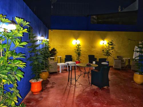 a room with a table and chairs and plants at Dar Rehab in Rabat