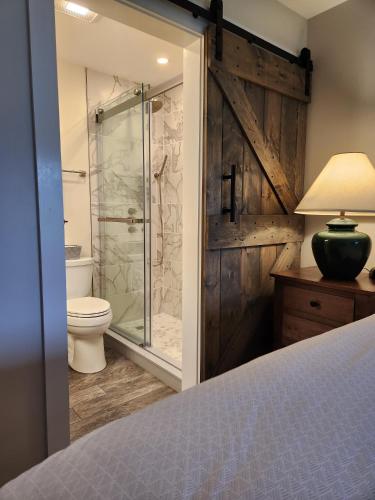 a bathroom with a shower and a toilet and a sink at Trail Creek: Walk to lifts, ski home! Closest unit to lifts, ski home trail, sports center in Killington