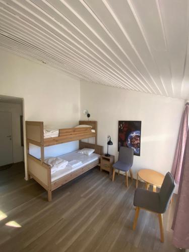 a room with a bed and a desk and a chair at Overnattingsrom Rudshøgda in Eriksrud