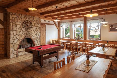 a room with a pool table and a fireplace at Wellness aparthotel Martiňák in Horní Bečva