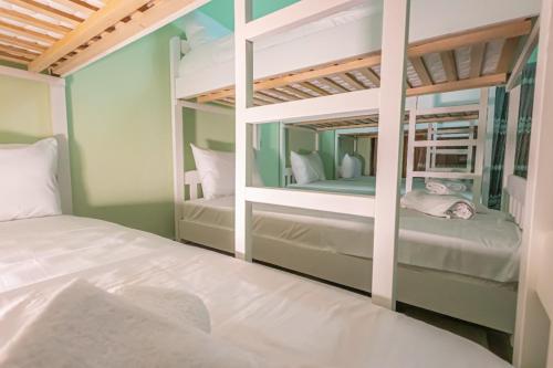 a bedroom with two bunk beds and a mirror at Relax Hostel in Tirana