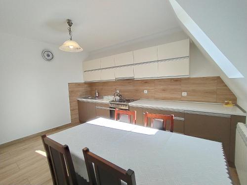 a kitchen with a table and chairs and a sink at Apartament in Zakopane