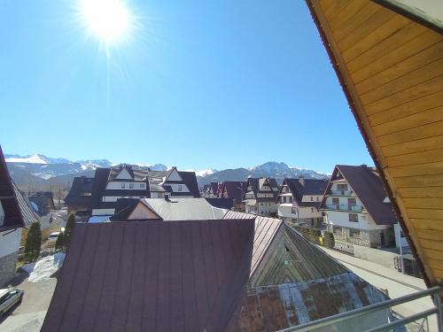 a view of a city with houses and mountains at Apartament in Zakopane