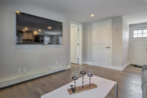 a living room with a table with wine glasses on it at Long Island Home Near Beaches and Golf in Bellmore