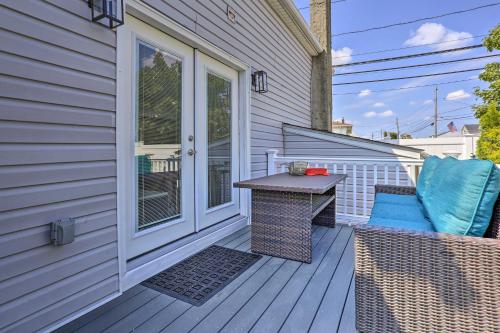 a patio with a table and chairs on a house at Long Island Home Near Beaches and Golf in Bellmore