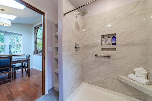 a bathroom with a walk in shower next to a table at Magic Garden in Arcata