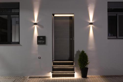 a house with lights on the side of it at BillMar Luxury Apartment in the center of Gythio in Gythio