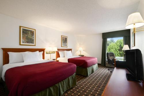 a hotel room with two beds and a window at Baymont by Wyndham Crossville in Crossville