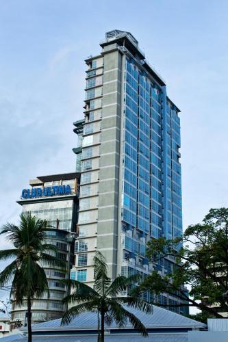 a tall building with palm trees in front of it at Crown Regency Hotel & Towers in Cebu City