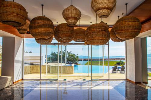a room with large windows and wicker baskets hanging from the ceiling at Eurobuilding Hotel & Suites Lecheria in El Morro de Barcelona
