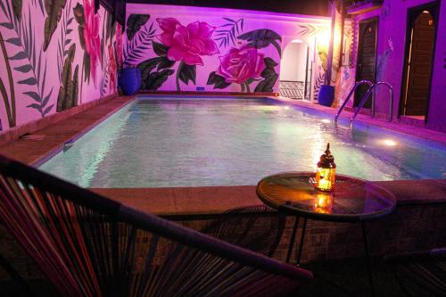 a swimming pool with a table in front of it at Majorel Pearl Hotel-Riad-Restaurant Piscine&Spa in Marrakech