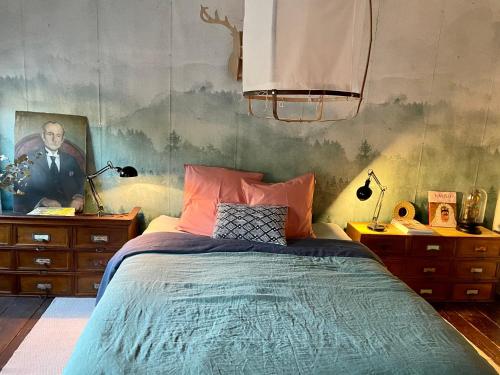 a bedroom with a bed and a painting on the wall at Villa Grimm in Sainte-Marie-aux-Mines