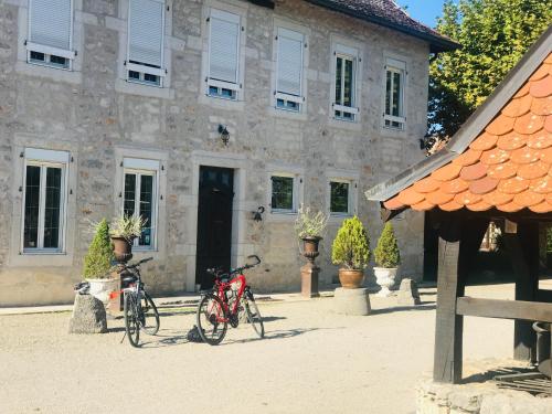 two bikes parked in front of a building at Domaine du Manoir in Les Avenières