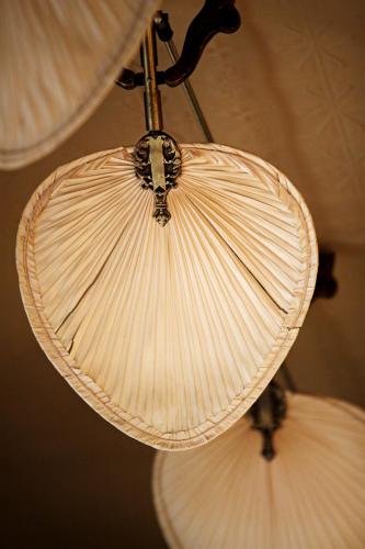 two white lights are hanging from a ceiling at Largs Pier Hotel in Adelaide