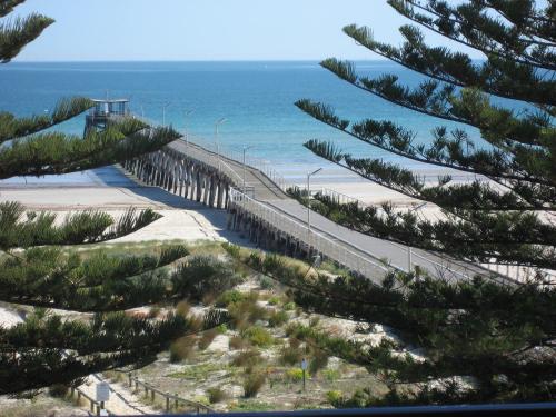 a view of a beach with trees and the ocean at Largs Pier Hotel in Adelaide