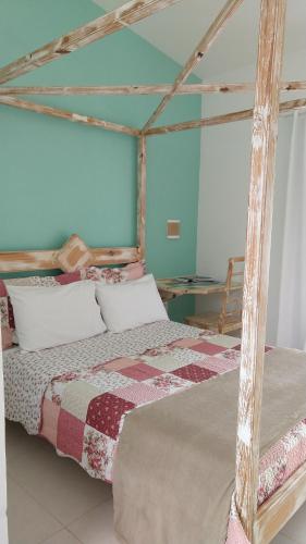 a bedroom with a bed with a quilt on it at Aloha Itaúna in Saquarema