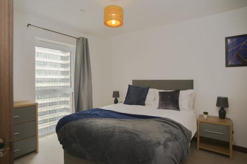 a bedroom with a large bed and a window at Amazing Central Southend,2-bedroom flat,10th floor in Southend-on-Sea