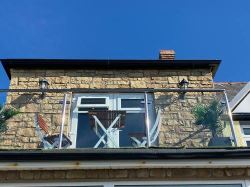 a window on the roof of a house with a windmill at The Gaslight Inn Self Catering Holiday Apartments Rossnowlagh Donegal in Rossnowlagh