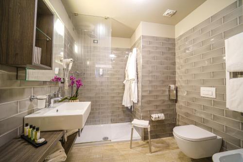 a bathroom with a sink and a toilet at Nautilus Family Hotel in Pesaro