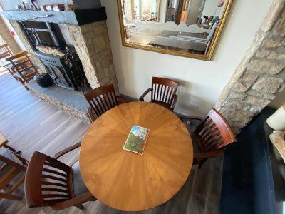 a wooden table and chairs in a living room at The Gaslight Inn Self Catering Holiday Apartments Rossnowlagh Donegal in Rossnowlagh