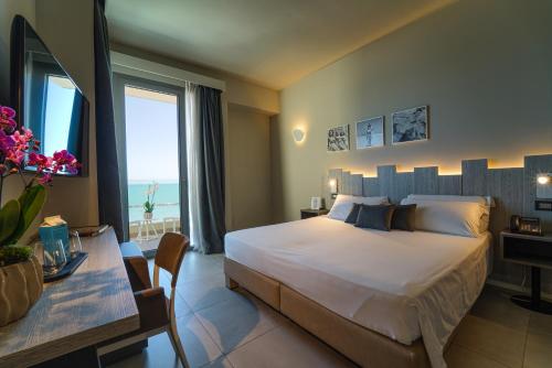 a hotel room with a bed and a table with a table sidx sidx at Nautilus Family Hotel in Pesaro