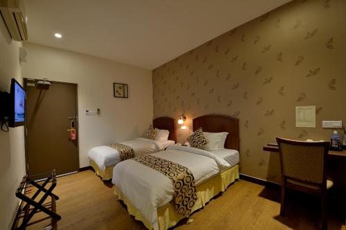 Postel nebo postele na pokoji v ubytování Asiana Hotel