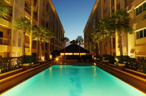 a swimming pool in the middle of a building at The Ninth Place Serviced Residence in Bangna