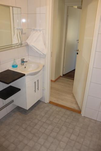 a bathroom with a sink and a mirror at Holiday Home Kokki in Rovaniemi