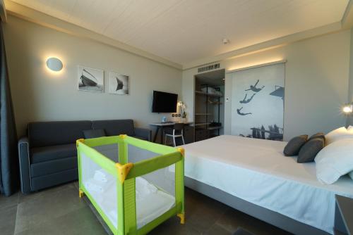 a bedroom with a large bed and a couch at Nautilus Family Hotel in Pesaro